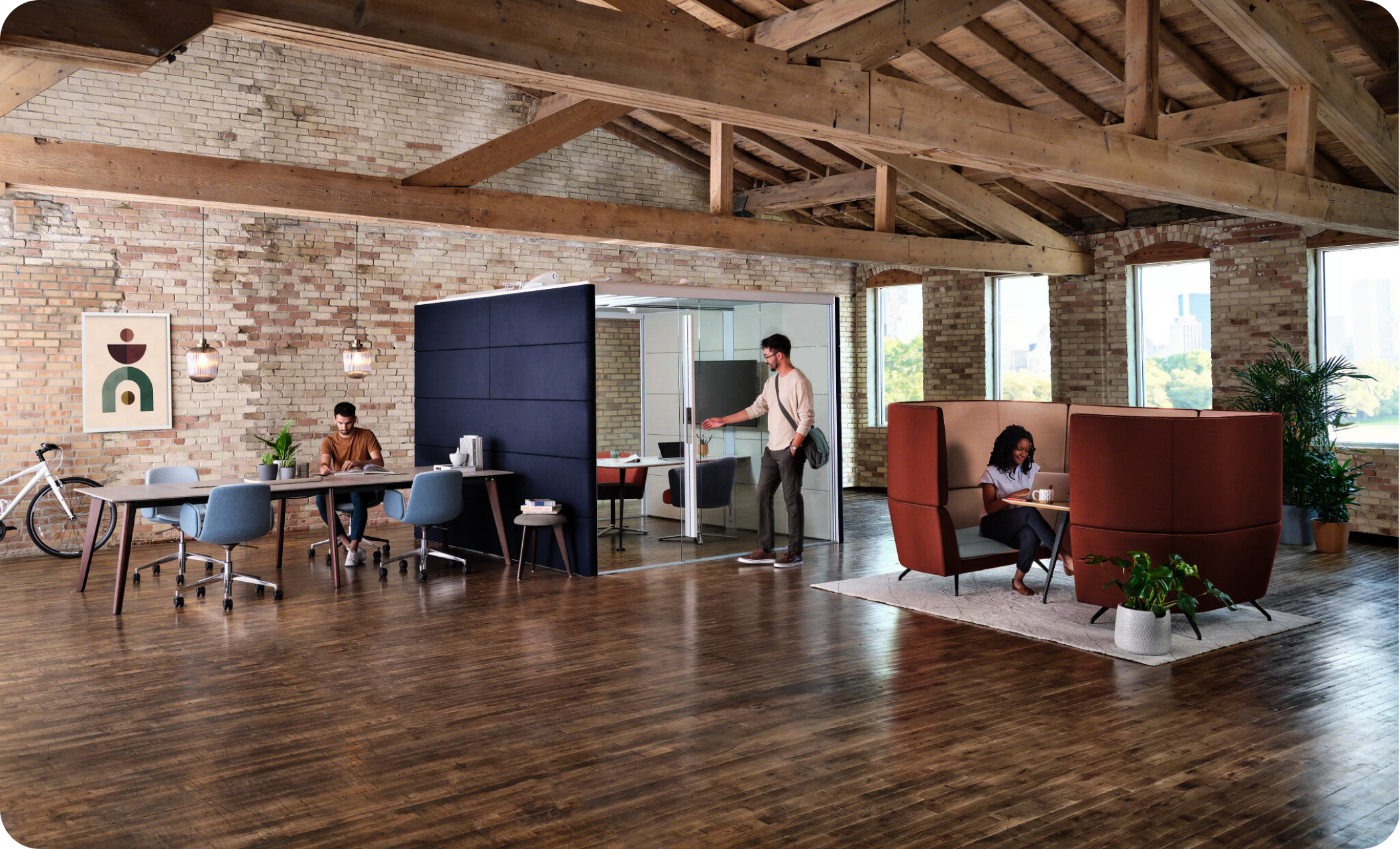 Collaborative workspace with Orangebox furniture featuring privacy pods, a modern meeting table, and vibrant office seating in a loft-style environment.